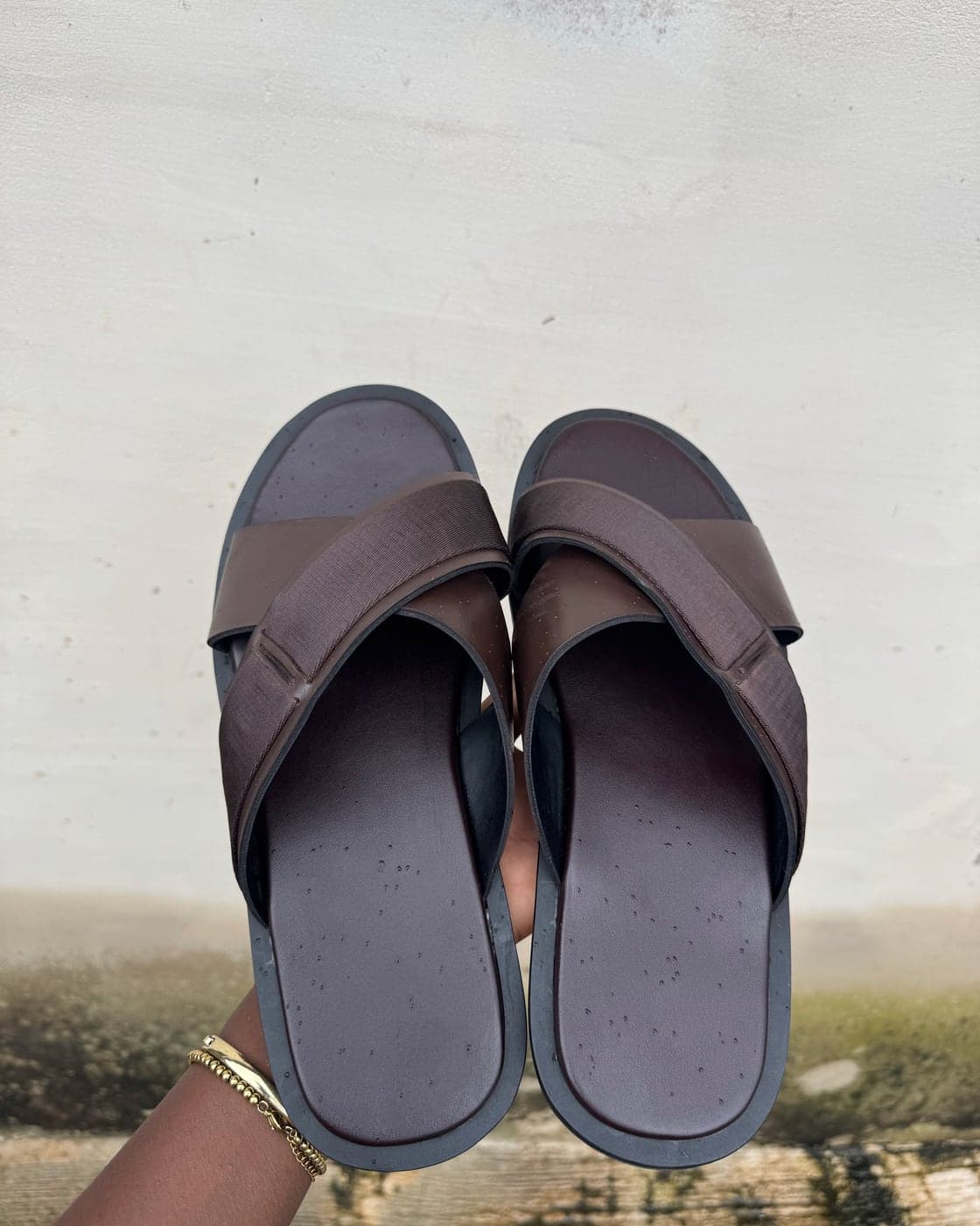 The Textured Cross Slide in Brown, with a textured crossed leather strap and a leather-lined footbed